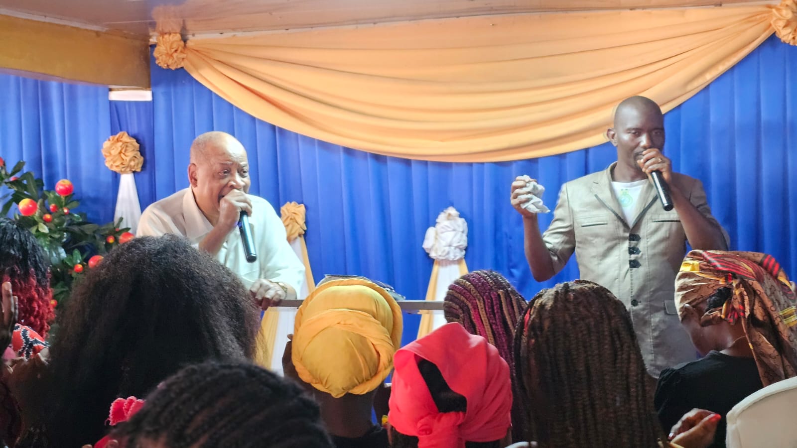 Bishop Butler and pastor ministering on stage