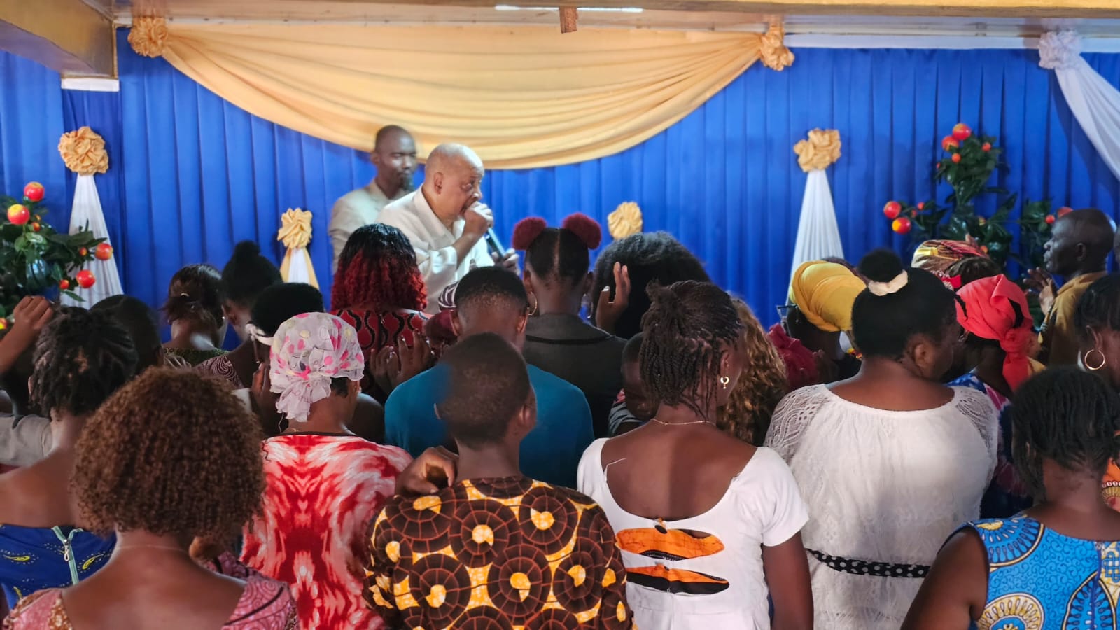 Congregation gathered in prayer at the altar